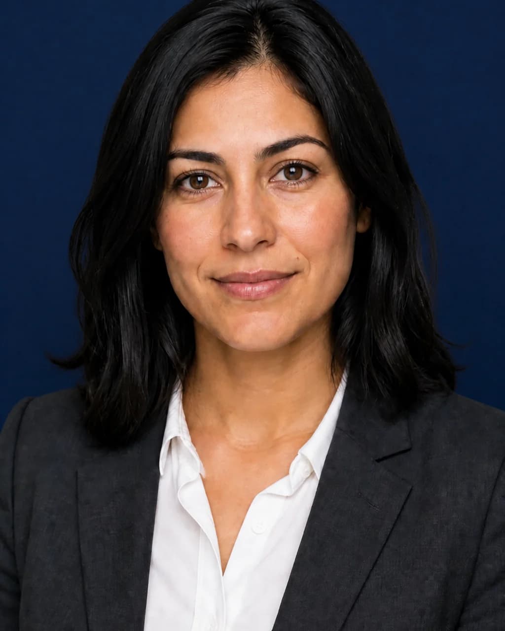 The same woman photographed on a deep navy studio background