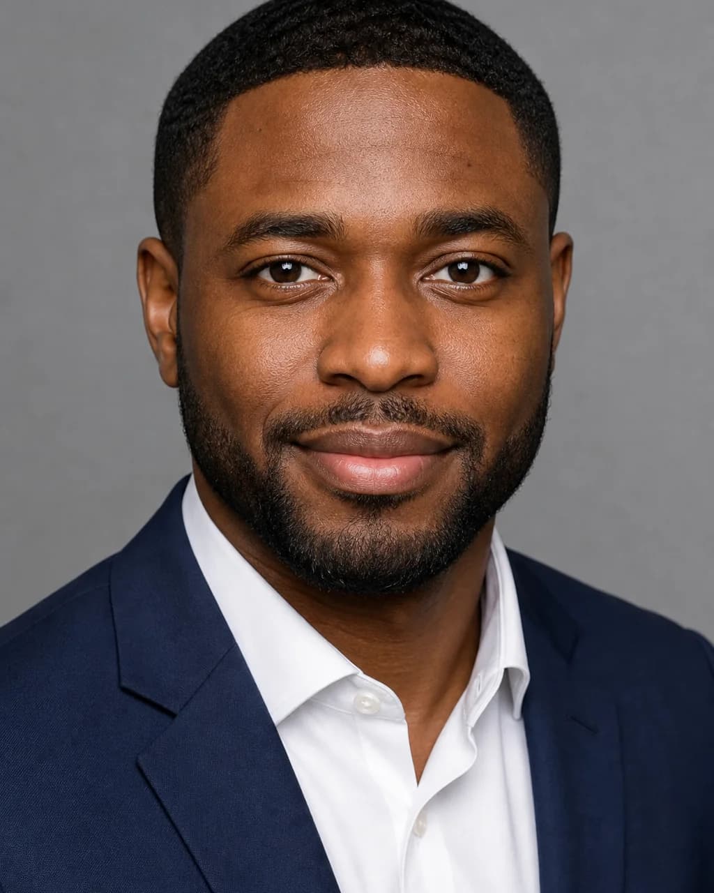 Tightly framed professional headshot of a man on a neutral background