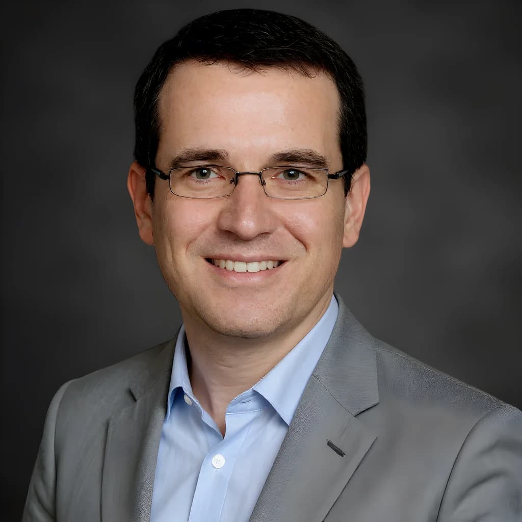 Professional headshot on a charcoal studio background