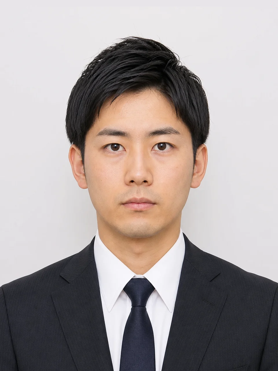 Japanese rirekisho photo example: man in dark suit, minimal expression, plain background, 3 by 4 centimeter framing